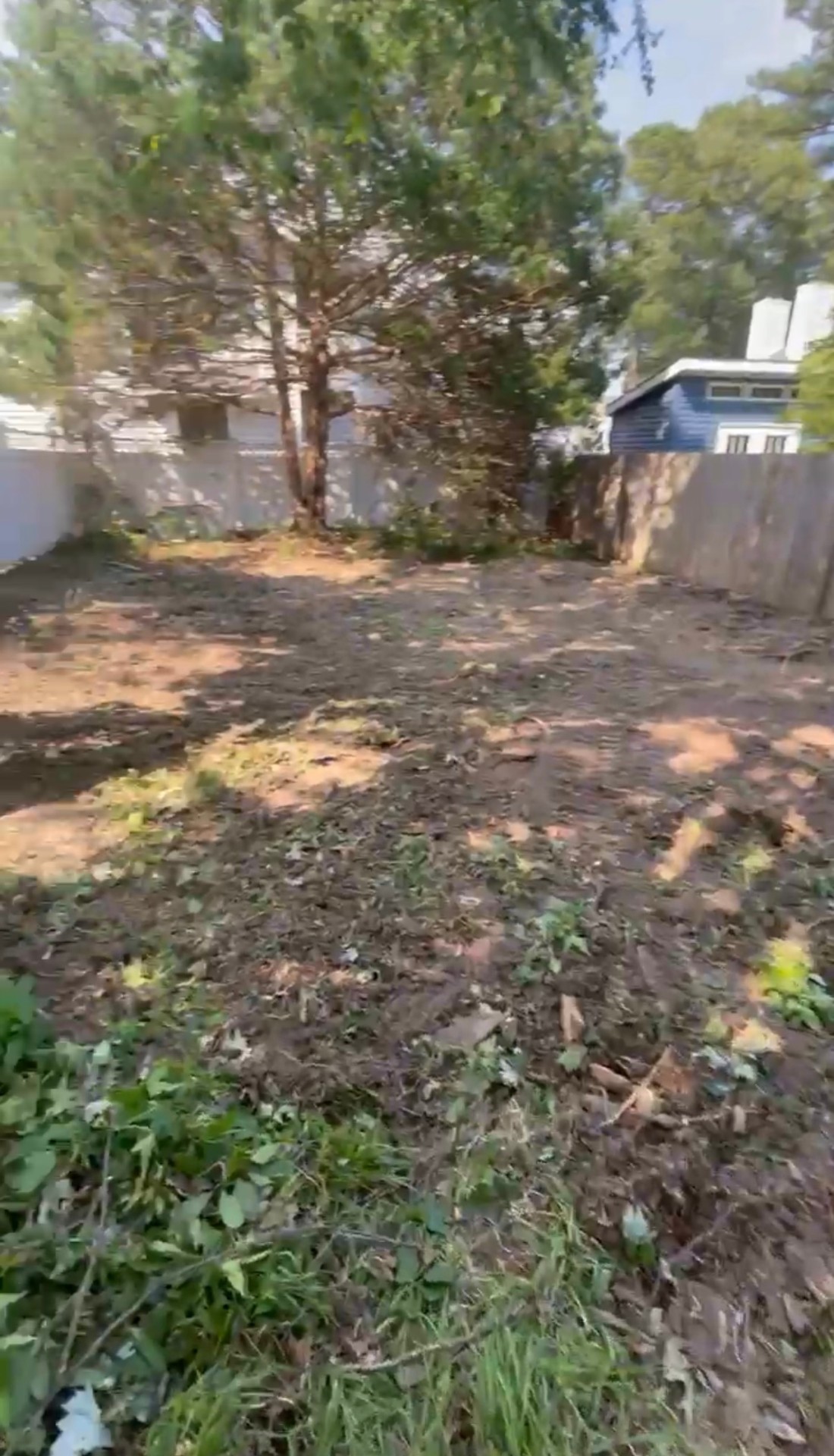Land clearing and grading with heavy equipment on a Hampton Roads lot
